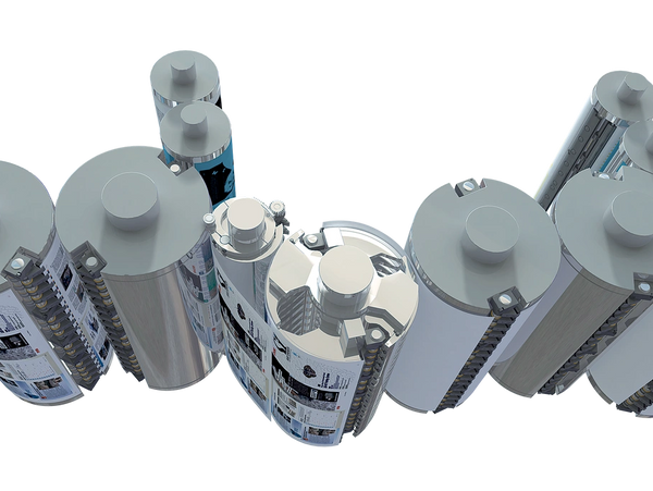 Printing press rollers with newspapers being printed.