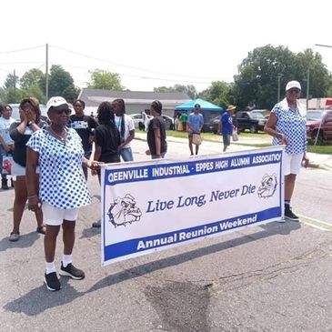 Two women hold a reunion banner for Greenville Industrial-Eppes High Alumni.