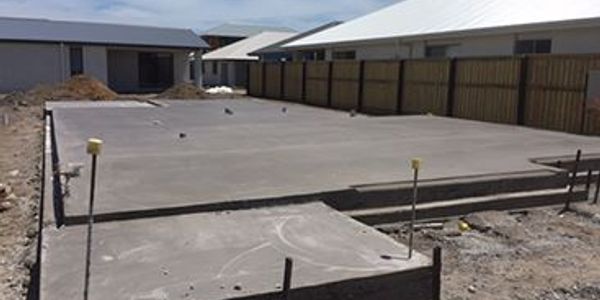 Concrete slab foundation prepared at a residential construction site.