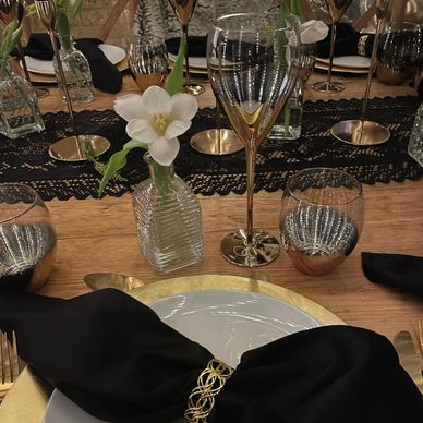 Black napkins cutlery gold charger plates napkin rings rustic decor dinner party bud vases table sty