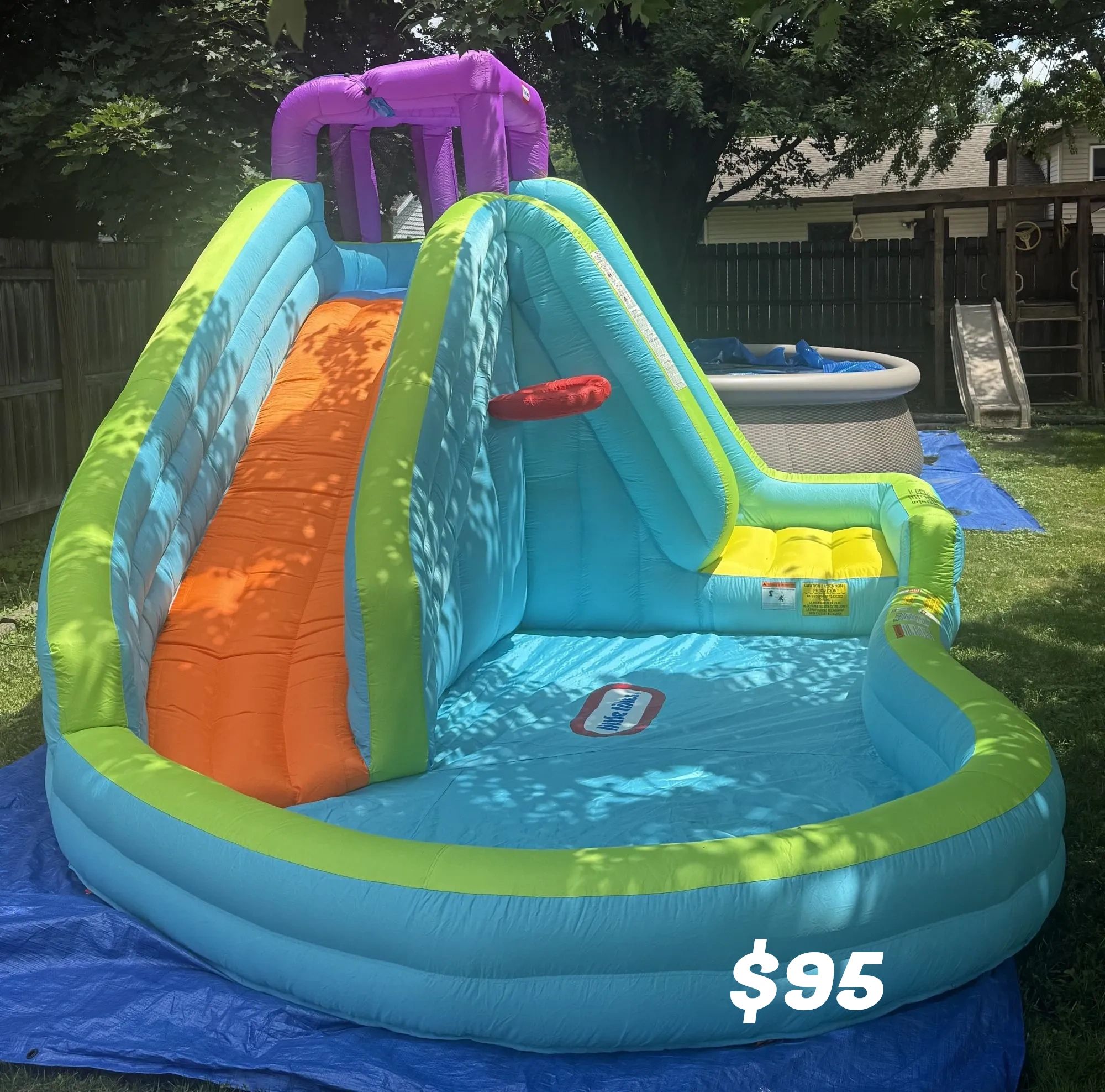 Colorful inflatable water slide for $95 in a backyard.