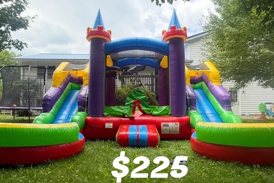 Colorful inflatable bounce house with slides.