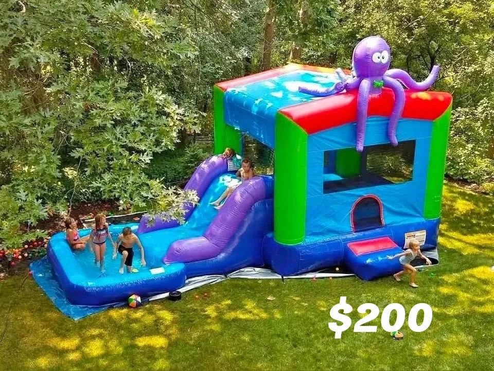 Colorful inflatable bounce house with water slide and kids playing.