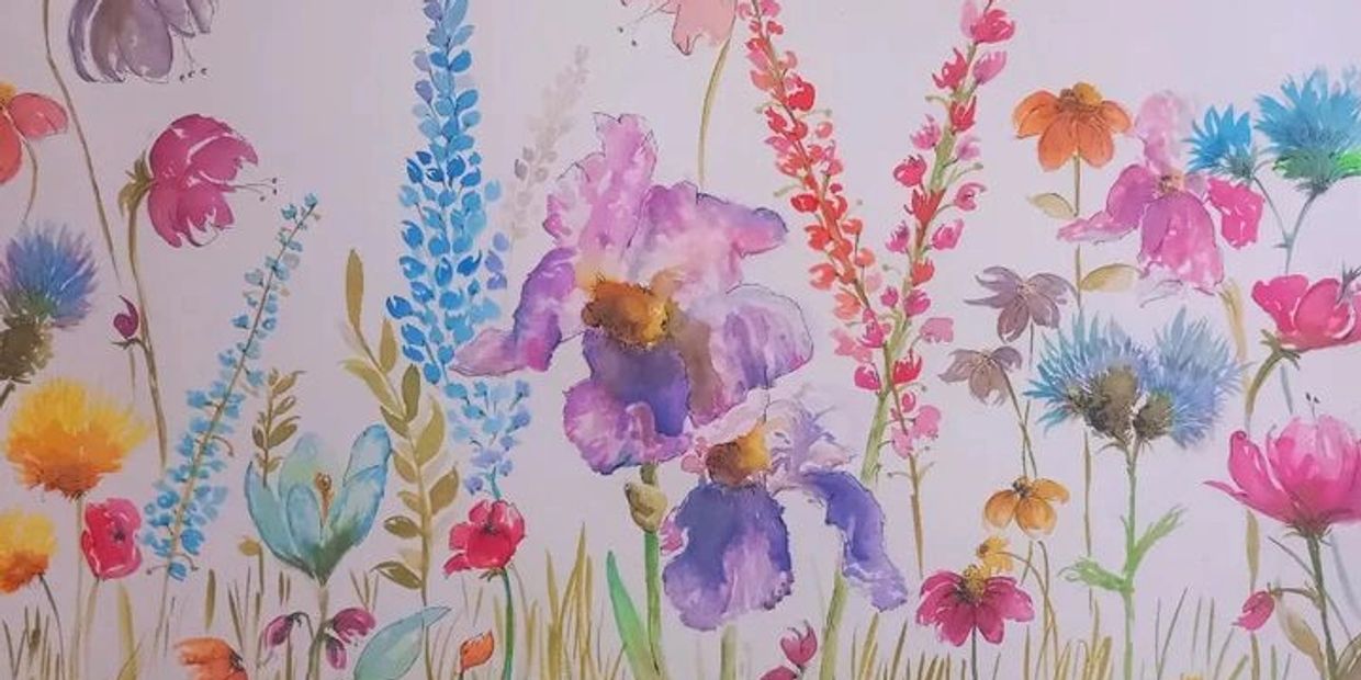 Watercolor painting of colorful wildflowers in various shades.