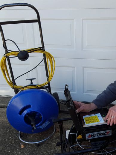 plumber working with sewer drain machine