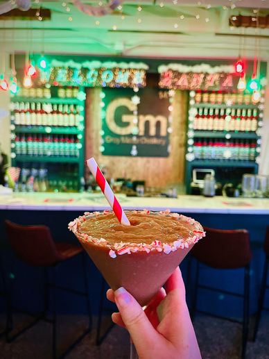 Chocolate drink with peppermint rim in a festive setting.