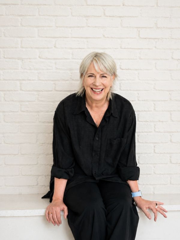 Registered Provisional Psychologist seated against a white brick wall