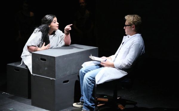 Two people in a dramatic scene, one dressed as a doctor.