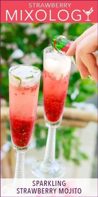 Two sparkling strawberry mojitos being prepared in elegant glasses.