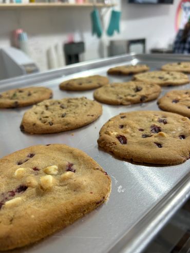 Freshly baked cookies cooling on a metal tray.