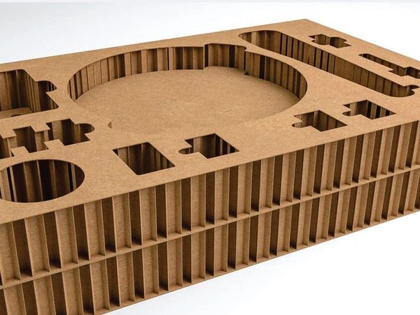 Cardboard packaging insert with various cutouts.