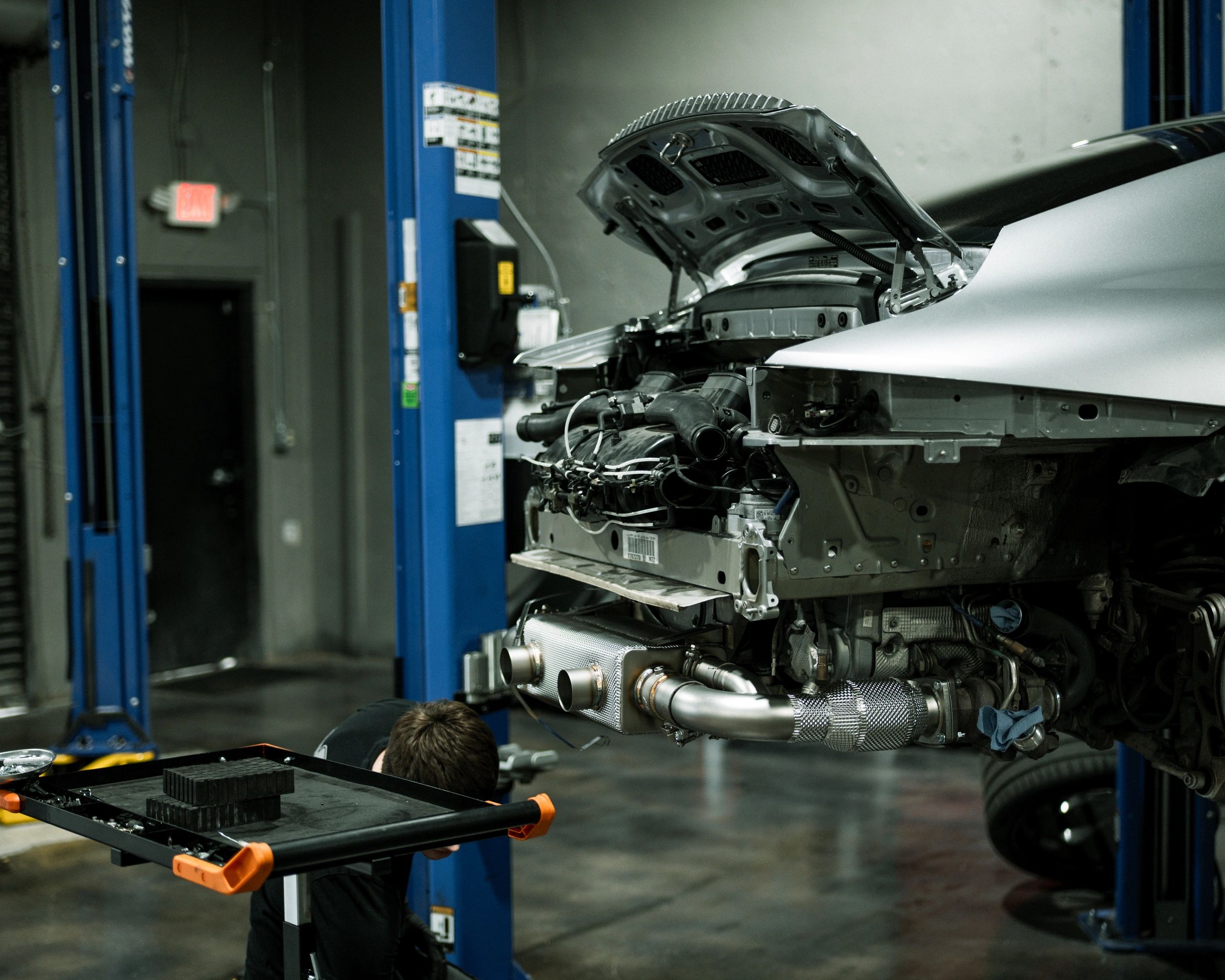 Porsche 911 receiving aftermarket exhaust upgrade at Wolfpen in Atlanta, Georgia