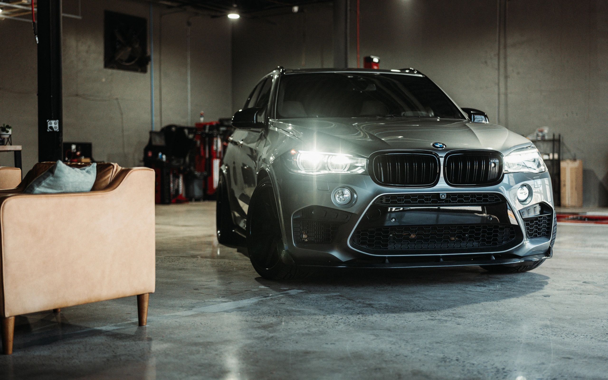 BMW X5 M in Wolfpen main bay next to customer service area and alignment rack in Roswell, Georgia