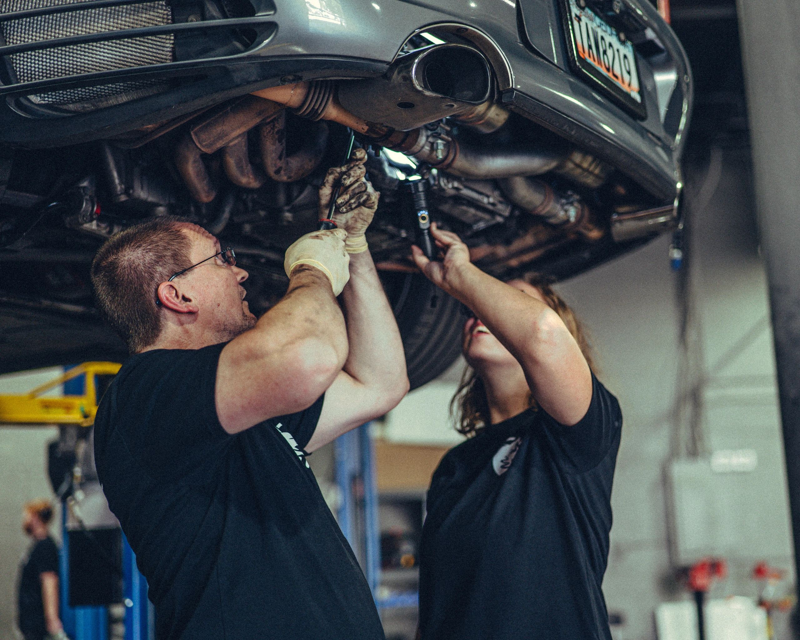 A Porsche gold master tech teaching a Porsche apprentice technician at Wolfpen in Roswell, Georgia