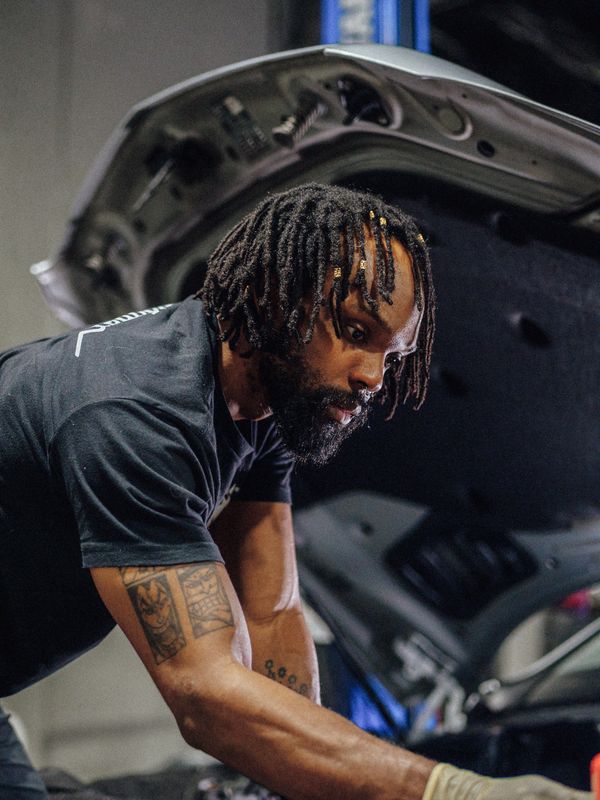 Porsche technician working on Mercedes GLE engine repair at Wolfpen in Roswell, Georgia