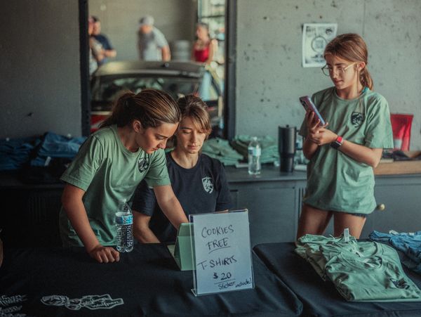 Wife and daughters selling merchandise at the Grand Opening of Wolfpen in Roswell, Georgia