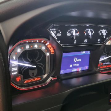 Close-up of a car dashboard showing speedometer and tachometer.