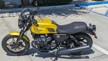 A yellow motorcycle parked outdoors.