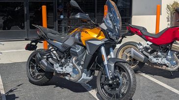 Yellow adventure motorcycle parked outdoors.