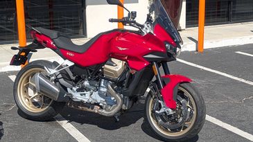 Red sports motorcycle parked outside.