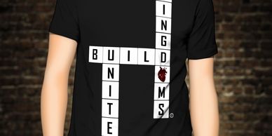 A person wearing a black shirt that says build united text
