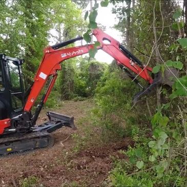 KX033-4 easily taking on the task of brush clearing and land clearing