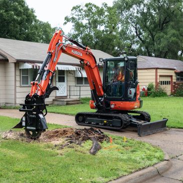 Our Kubota excavator handling tree stump grinding and tree stump removal