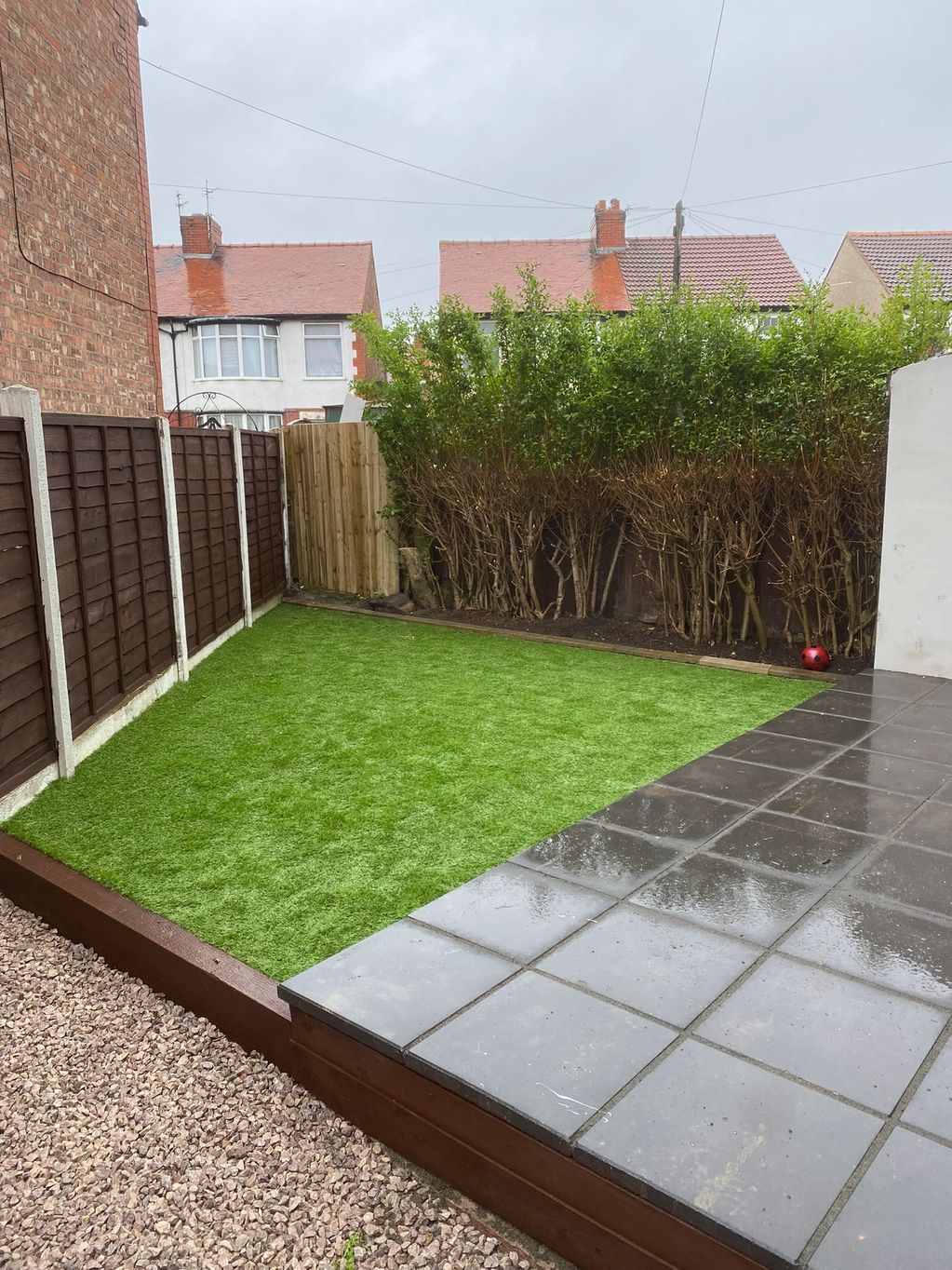 artificial grass and paved back garden