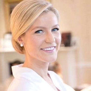 Smiling woman with blonde hair.