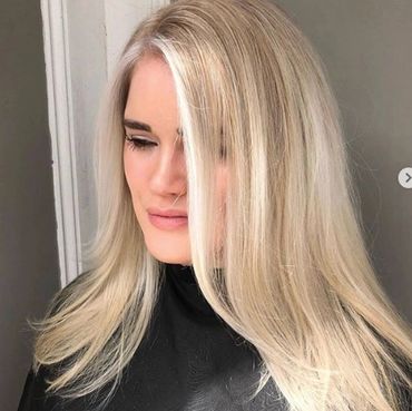 Woman with blonde hair smiling.