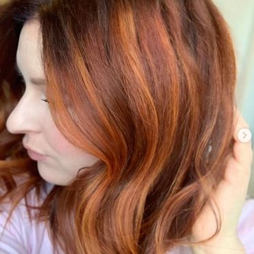 Side profile of woman with red hair.