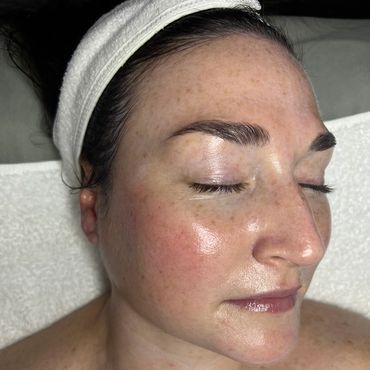 Woman with a headband, eyes closed.