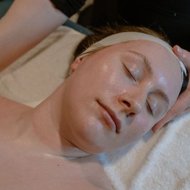 Woman receiving facial treatment.