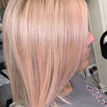 Woman with short pink hair.