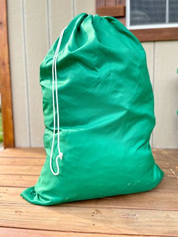 The Laundry Bag. A green nylon bag to protect blankets, comforters, towels, and clothing when moving