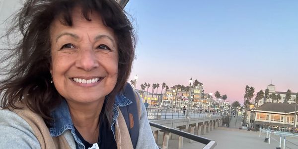 Chief SunBuddy Sandra Robbie with SunBuddy on sunnies at Huntington Beach Pier. Save the Shades!