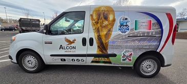 A media company van with World Cup-themed graphics and logos.