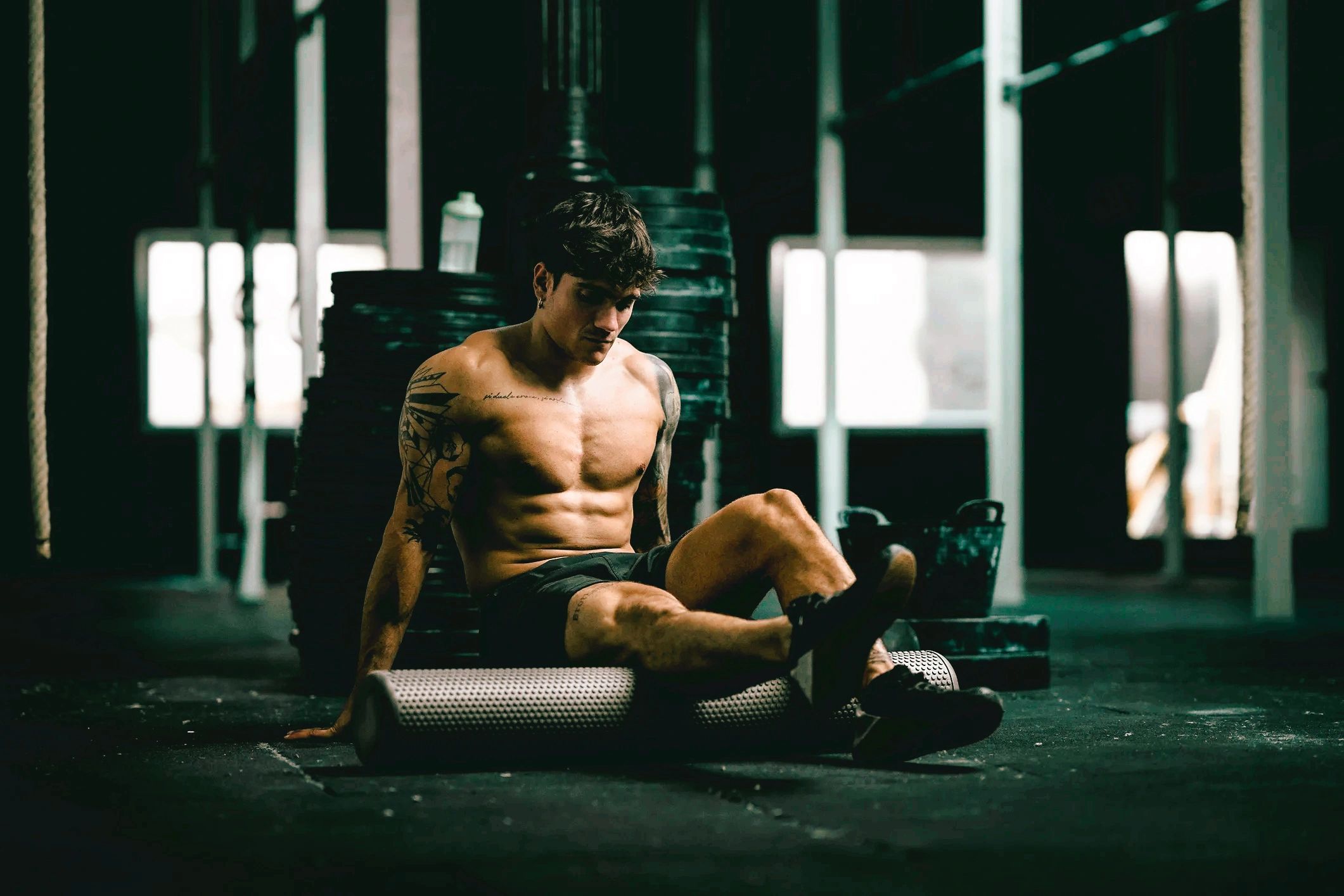 Athlete using foam roller for sports injury recovery – therapy and rehabilitation in Chingford.