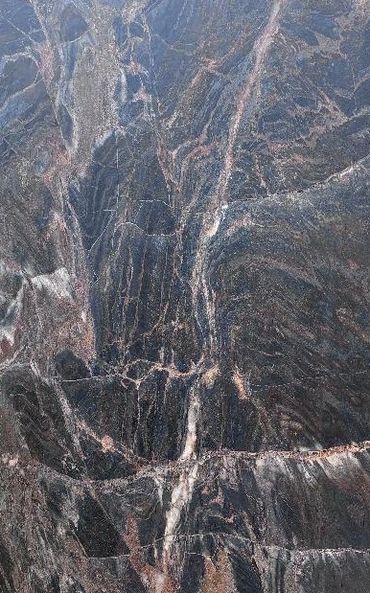 Close-up of a dark marble surface with intricate veining patterns.