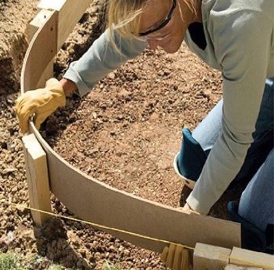 A person bending TruForm Concrete forms into a quarter circle for shaping concrete