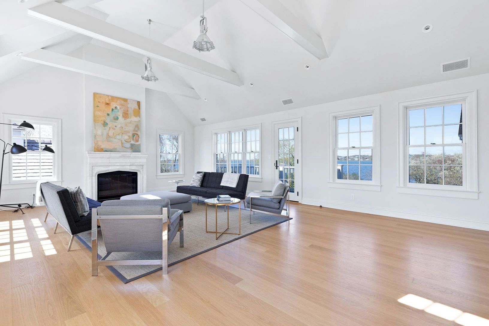 Bright modern living room with water view.