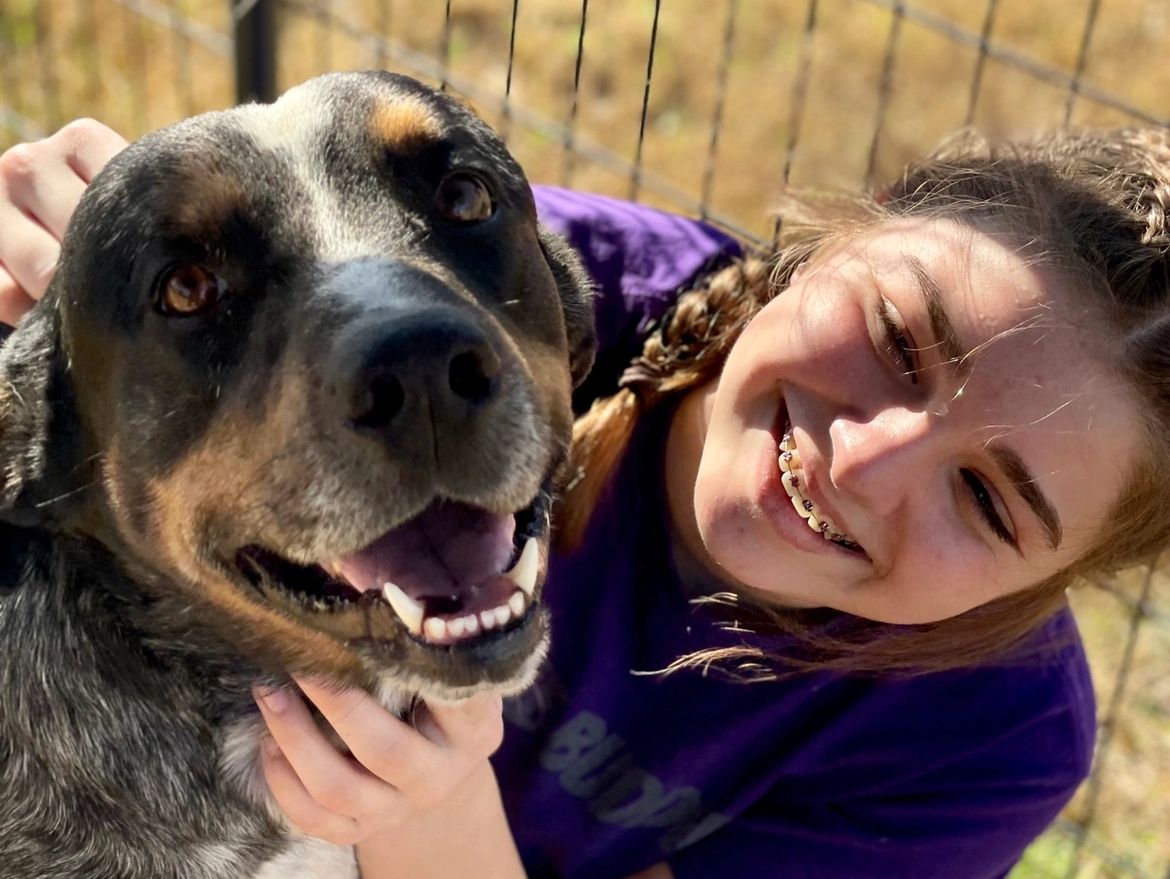 Dog and girl both smiling