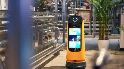 Delivery robot with a front-facing screen in a restaurant