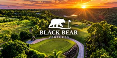 Sunset view over a golf course with Black Bear Ventures logo.