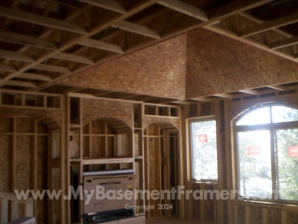 Basement framing with  pyramid ceiling and arches around fireplace.