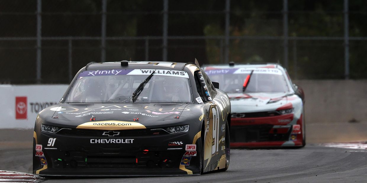 Two race cars competing on a track during a NASCAR Xfinity Series event.
