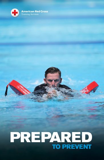 A man practices water rescue with a flotation device in a pool.
