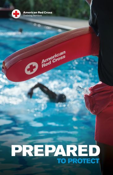 Lifeguard with American Red Cross floatation device at poolside.