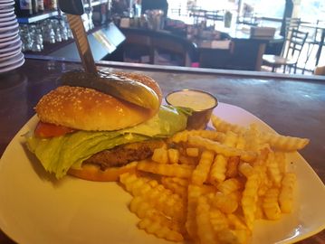 hamburger and French Fries on a plate with a dipping sauce