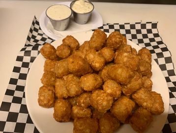 French Fries or Tater tots and dipping sauces on a plate